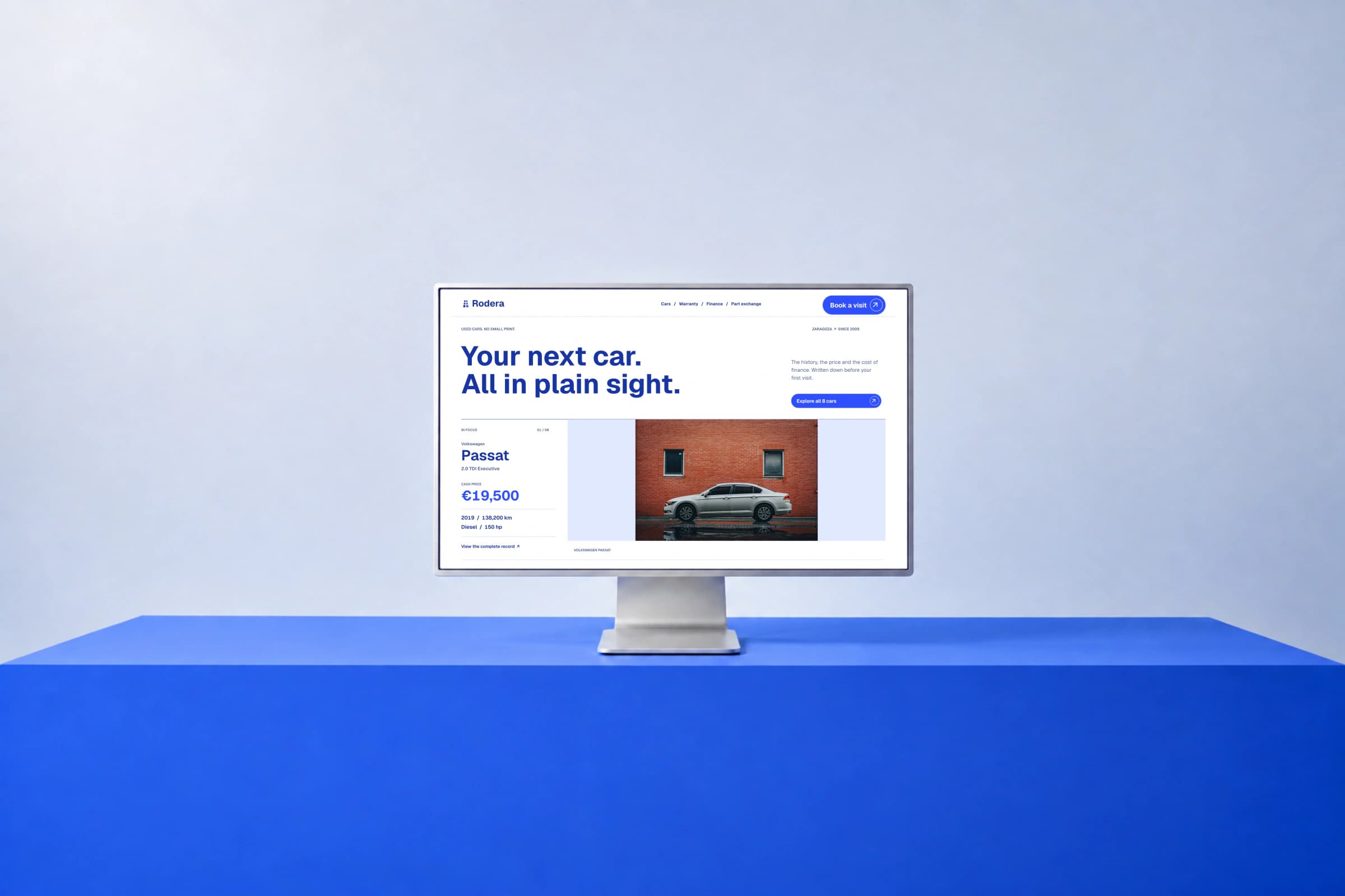 Rodera homepage displayed on a silver monitor above a blue plinth, with a pale studio background.