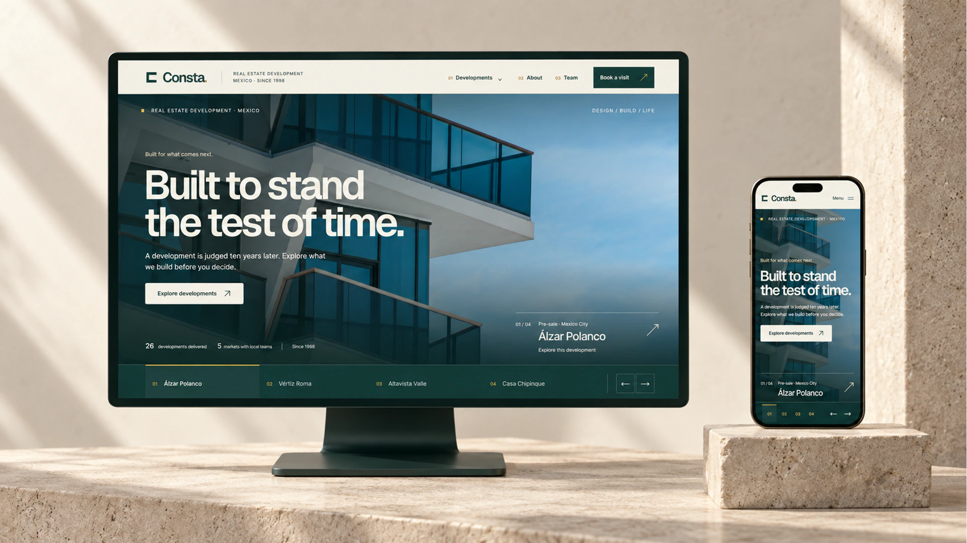 Desktop and mobile Consta mockups presented on separate limestone surfaces in a warm architectural studio.